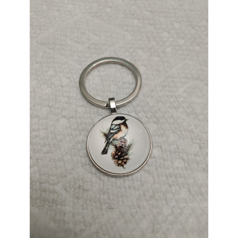 Chickadee bird on pine cone key chain.
